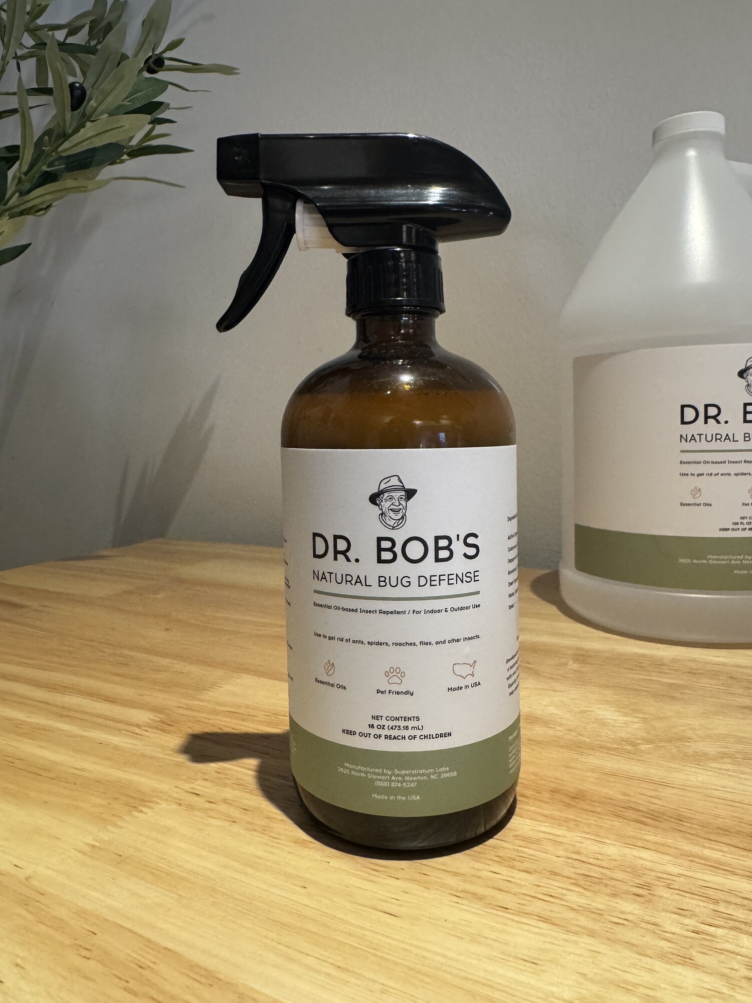 Dr. Bob's Natural Bug Defense 16 oz spray bottle with the one-gallon jug behind it